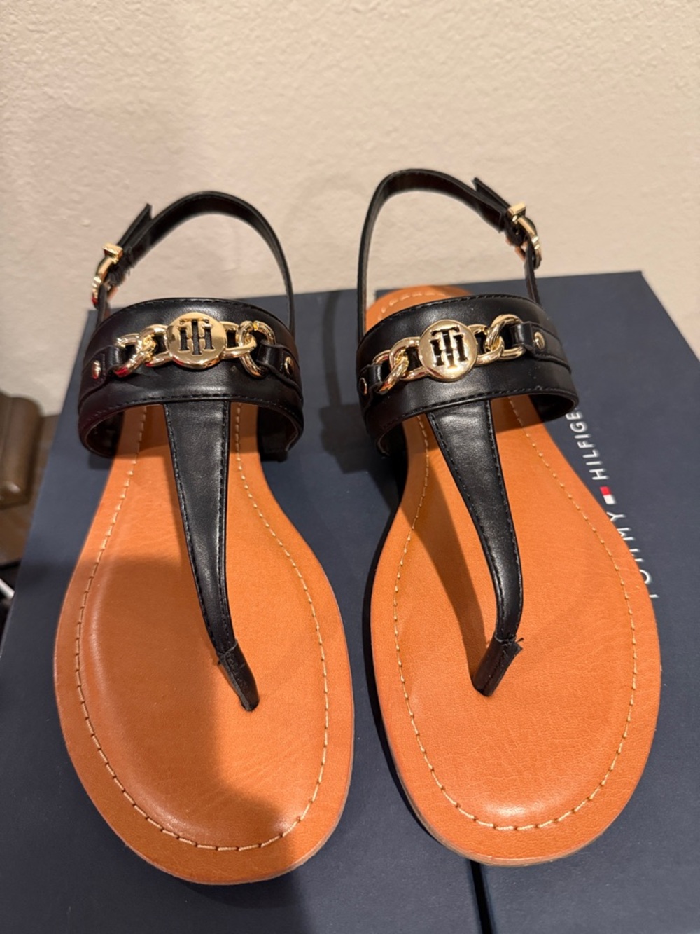 Tommy Hilfiger Black Leather T-Strap Sandals with Gold Chain Emblem
